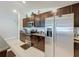 Kitchen with stainless steel appliances, dark cabinets, granite countertops, and tile floors at 2929 Flying Blackbird Rd, Bartow, FL 33830