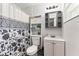 Cozy bathroom features patterned shower curtain and functional storage solutions at 3016 Reiter Dr, Auburndale, FL 33823