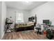 Comfortable bedroom with wood-look floors, a desk, and a window with natural light at 3016 Reiter Dr, Auburndale, FL 33823