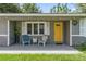 Charming front porch with seating area and decorative door at 3016 Reiter Dr, Auburndale, FL 33823