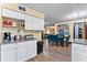 Open layout of kitchen with view into dining area and living room at 3016 Reiter Dr, Auburndale, FL 33823