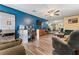 Open-concept living area with blue accent wall and direct access to another room at 3016 Reiter Dr, Auburndale, FL 33823