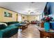 Comfortable living room featuring wood floors, ceiling fan, and bright accents at 3016 Reiter Dr, Auburndale, FL 33823