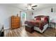 Inviting main bedroom with wood-look floors, a ceiling fan, and a dresser at 3016 Reiter Dr, Auburndale, FL 33823