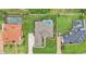 Overhead shot displaying backyard pool, manicured lawn, mature trees, and the home's expansive layout at 3121 Highlands By The Lake Way, Lakeland, FL 33812