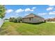 Well-maintained backyard with lush lawn, manicured hedges, and a private setting at 3121 Highlands By The Lake Way, Lakeland, FL 33812