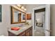 Bathroom featuring wood vanity with a granite counter and a mirror at 3121 Highlands By The Lake Way, Lakeland, FL 33812