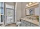Well-lit bathroom has a vanity with marble countertop, offering serene views of the pool through the patio door at 3121 Highlands By The Lake Way, Lakeland, FL 33812