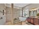Bright bathroom showcasing a modern soaking tub and large tiled shower with a glass door at 3121 Highlands By The Lake Way, Lakeland, FL 33812