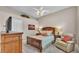 Comfortable bedroom features a queen bed, accent chair, and dresser at 3121 Highlands By The Lake Way, Lakeland, FL 33812