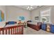 Bright bedroom featuring two wood-framed beds, a desk, and decorative maps at 3121 Highlands By The Lake Way, Lakeland, FL 33812