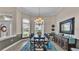 Elegant dining room with a decorative chandelier, large windows, and stylish decor at 3121 Highlands By The Lake Way, Lakeland, FL 33812