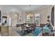 Bright dining room boasts modern chandelier, large windows, and a beautiful blue rug at 3121 Highlands By The Lake Way, Lakeland, FL 33812