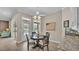 Bright dining room features wood floors, table with seating for four, and pool view at 3121 Highlands By The Lake Way, Lakeland, FL 33812