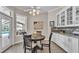 Bright dining room features wood floors, table with seating for four, and pool view at 3121 Highlands By The Lake Way, Lakeland, FL 33812