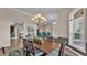 Dining room features a wooden table with seating for six and views into the living room at 3121 Highlands By The Lake Way, Lakeland, FL 33812