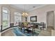 Elegant dining room with a decorative chandelier, large windows, and stylish decor at 3121 Highlands By The Lake Way, Lakeland, FL 33812
