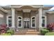 Welcoming entryway with a decorated glass door, brick steps and decorative planters at 3121 Highlands By The Lake Way, Lakeland, FL 33812