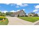 Spacious home with three-car garage, well-manicured landscaping, and a long driveway at 3121 Highlands By The Lake Way, Lakeland, FL 33812
