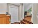 The charming hallway features hardwood floors and a closet, seamlessly connecting the bonus room to the peaceful sitting area at 3121 Highlands By The Lake Way, Lakeland, FL 33812