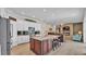 Open concept kitchen with stainless steel appliances, an island, and views into the living room at 3121 Highlands By The Lake Way, Lakeland, FL 33812