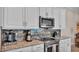 Close up of the kitchen with stainless steel microwave, coffee maker, and tile backsplash at 3121 Highlands By The Lake Way, Lakeland, FL 33812