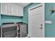 The laundry room is equipped with modern appliances, ample cabinet space, and easy access to the rest of the home at 3121 Highlands By The Lake Way, Lakeland, FL 33812