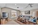 Cozy living room featuring a gray sectional sofa, a wood coffee table, and a large window at 3121 Highlands By The Lake Way, Lakeland, FL 33812