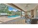 The screened-in patio is an excellent place to relax by the pool with ample outdoor seating and a dining area at 3121 Highlands By The Lake Way, Lakeland, FL 33812