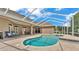 A screened in pool with brick pavers surrounded by the exterior of the home at 3121 Highlands By The Lake Way, Lakeland, FL 33812