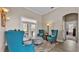 Sitting area showcases three blue chairs, an ottoman, and a large doorway to the patio at 3121 Highlands By The Lake Way, Lakeland, FL 33812