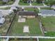 Aerial view of the backyard with a fenced perimeter and lush greenery at 322 Ne 9Th St, Mulberry, FL 33860