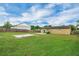 Spacious backyard with a lush green lawn and a fenced perimeter at 322 Ne 9Th St, Mulberry, FL 33860