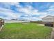 Large backyard with a grill, wooden fences, and concrete slabs at 322 Ne 9Th St, Mulberry, FL 33860