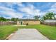 Backyard featuring a well-maintained lawn and a concrete patio area at 322 Ne 9Th St, Mulberry, FL 33860