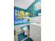 Bathroom with a palm tree themed shower curtain and blue walls at 322 Ne 9Th St, Mulberry, FL 33860