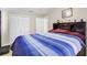 Bedroom featuring a large bed with a blue comforter and built in headboard at 322 Ne 9Th St, Mulberry, FL 33860