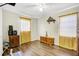 Bedroom with hardwood floors, modern ceiling fan, and ample natural light at 322 Ne 9Th St, Mulberry, FL 33860