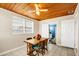 Charming dining area adjacent to the bathroom, featuring a wooden table, four chairs, and a ceiling fan at 322 Ne 9Th St, Mulberry, FL 33860