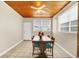 Cozy dining area with a rustic wood table, seating for four, and a unique wood-paneled ceiling at 322 Ne 9Th St, Mulberry, FL 33860