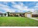 Charming single-story home featuring a well-manicured lawn and mature landscaping, enhancing its curb appeal at 322 Ne 9Th St, Mulberry, FL 33860