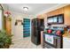 Practical kitchen area with wood cabinets, essential appliances, and a convenient open shelving unit at 322 Ne 9Th St, Mulberry, FL 33860