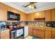 Cozy kitchen featuring wood cabinets, updated backsplash, and essential appliances for a functional cooking space at 322 Ne 9Th St, Mulberry, FL 33860