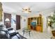 Bright living room featuring a comfortable sofa, a wooden entertainment center, and a view of the entryway at 322 Ne 9Th St, Mulberry, FL 33860