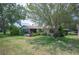 Lush backyard showcasing mature trees and well-maintained landscaping surrounding the property at 5 Pine Run, Haines City, FL 33844