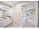 Bathroom view with granite countertop vanity and mirror leading to bedroom at 5 Pine Run, Haines City, FL 33844
