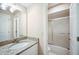 Bathroom vanity with white cabinets, granite countertop and a sliding glass door shower/tub at 5 Pine Run, Haines City, FL 33844
