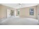 Bright bedroom with neutral walls and carpet, ceiling fan, and sliding door closet at 5 Pine Run, Haines City, FL 33844