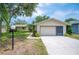 Charming single-story home with a two-car garage, lush landscaping, and inviting curb appeal at 5 Pine Run, Haines City, FL 33844