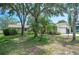 Charming single-story home with a well-maintained front yard and mature trees providing shade at 5 Pine Run, Haines City, FL 33844